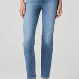 Woman wearing mid-wash straight-leg jeans with a streamlined, classic silhouette.