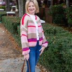 Striped knit cardigan worn open over a simple top