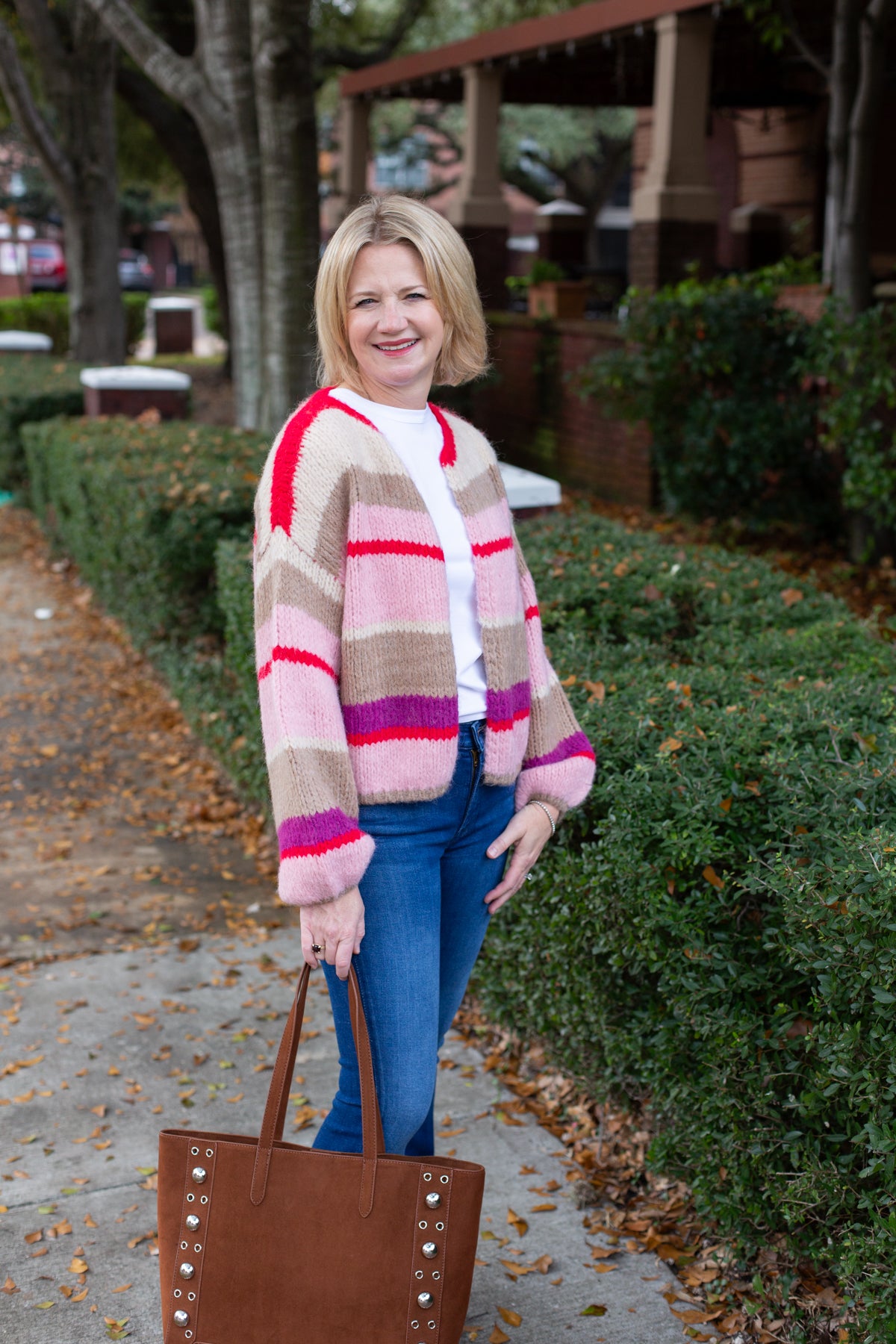 Striped knit cardigan worn open over a simple top