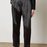 Black satin straight-leg pant with fly-front closure, styled with heels