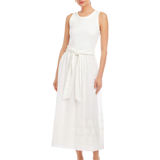 Woman wearing a white sleeveless dress with a belt on a white background