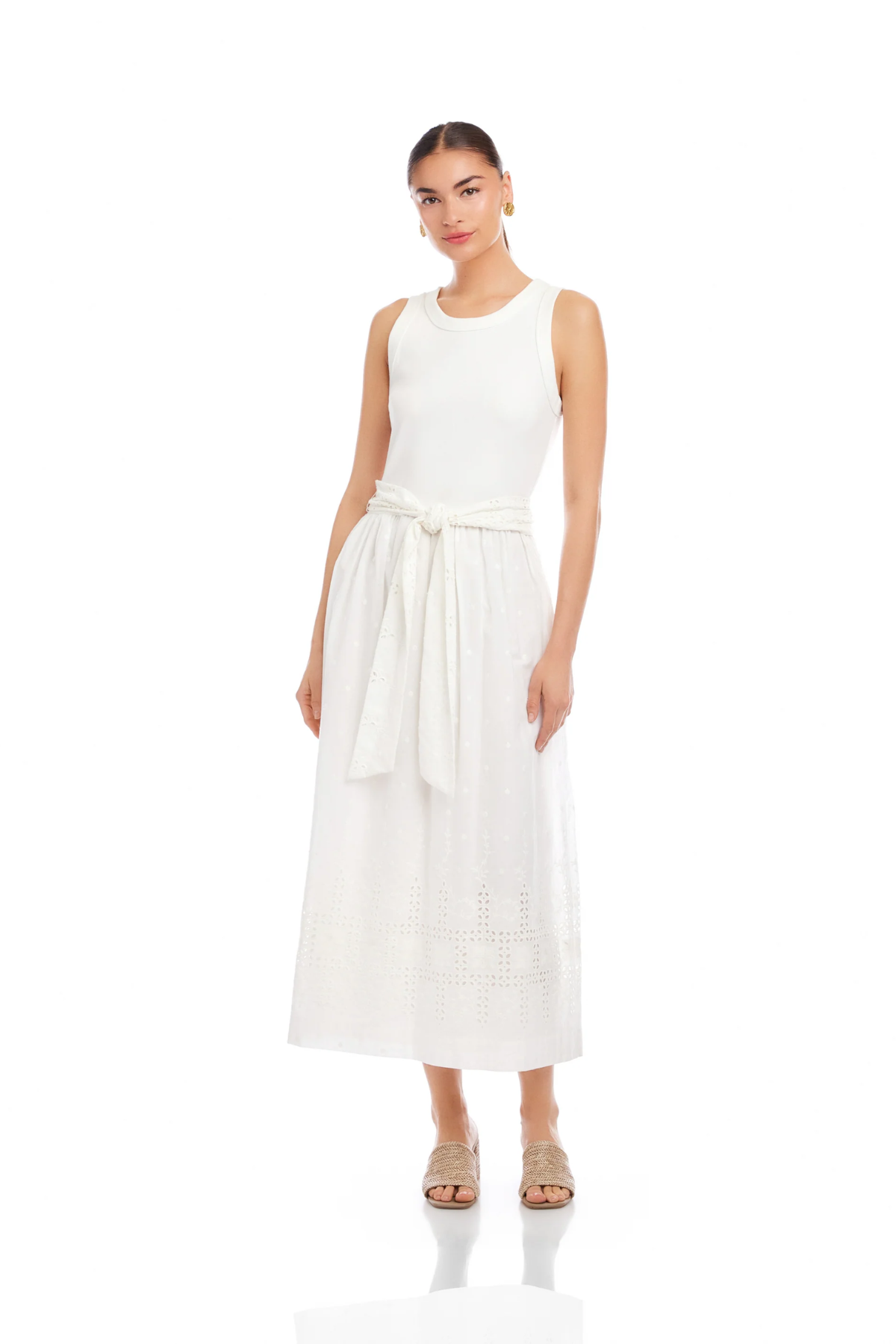 Woman wearing a white sleeveless dress with a belt on a white background