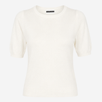 An off-white short-sleeve knit top with a crew neck and a small black label printed inside the collar, shown against a plain light gray background.