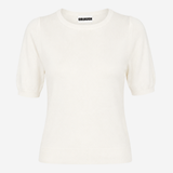 An off-white short-sleeve knit top with a crew neck and a small black label printed inside the collar, shown against a plain light gray background.