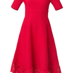 Elegant red dress with a fluid silhouette, styled for an evening setting.