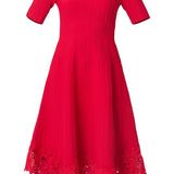 Elegant red dress with a fluid silhouette, styled for an evening setting.