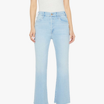 Person wearing light blue jeans and a white top on a white background