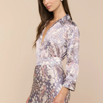 Woman wearing a floral patterned dress against a beige background