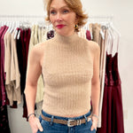 Ribbed sleeveless high-neck knit top styled with tailored bottoms