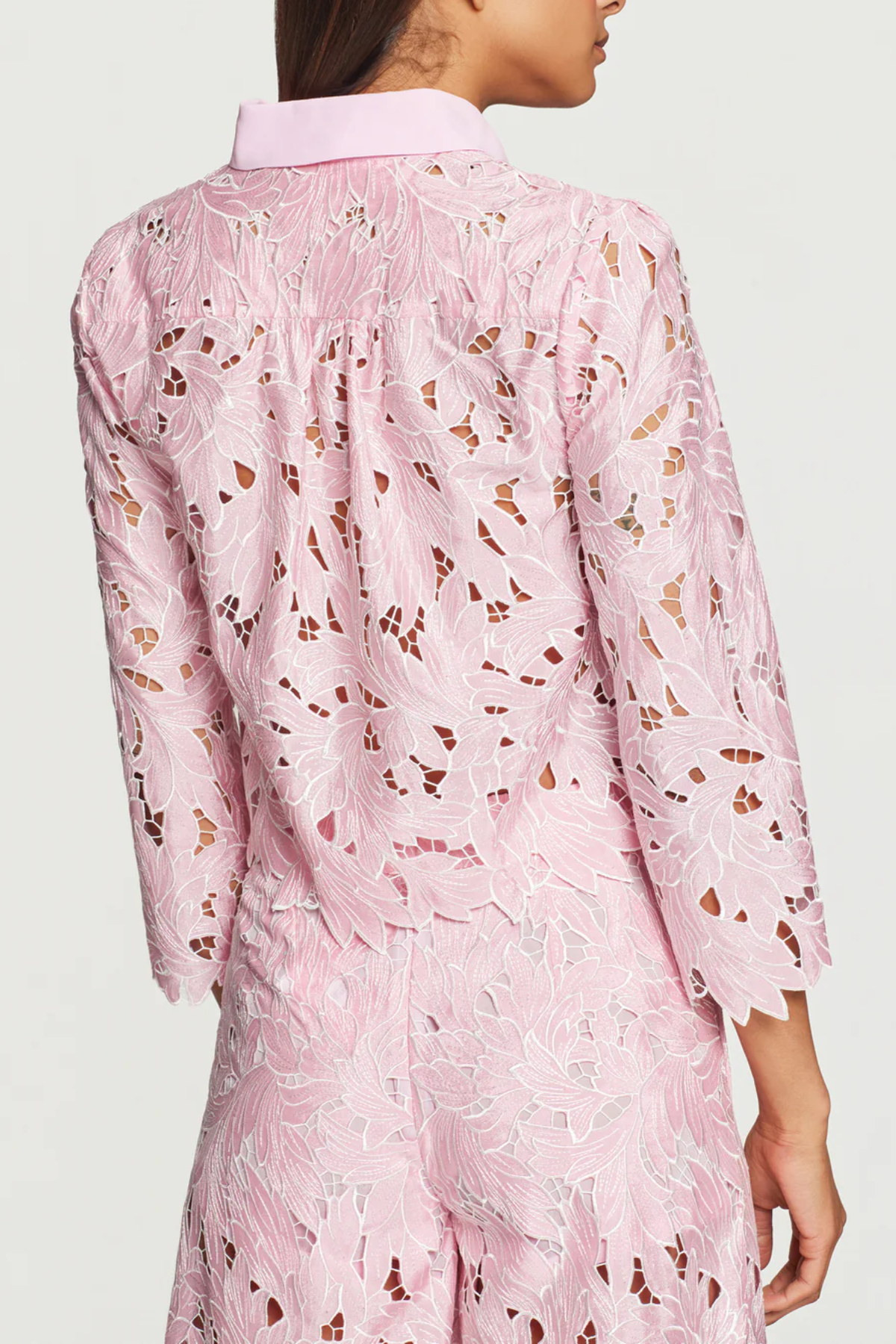 Pink floral dress worn by a person on a white background