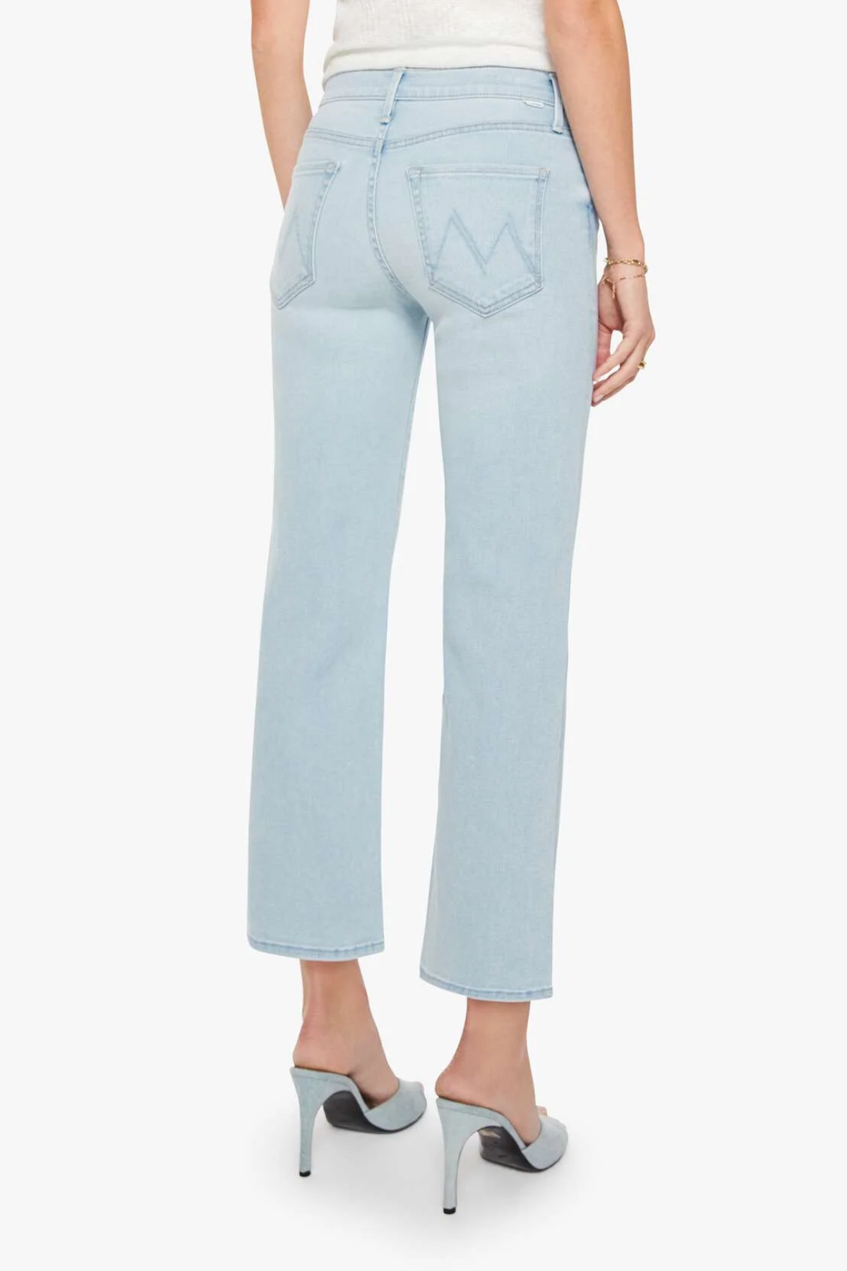 Light blue jeans worn by a person on a white background