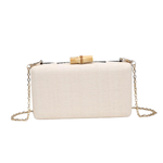 White clutch bag with gold chain and bamboo handle on a white background