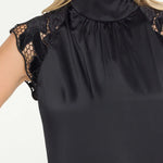 Black sleeveless top with lace details on a white background