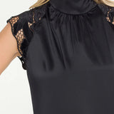 Black sleeveless top with lace details on a white background