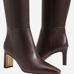 A pair of dark brown leather knee-high boots with pointed toes and block heels, shown against a plain light gray background.