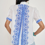 White top with blue printed detailing modeled on white background