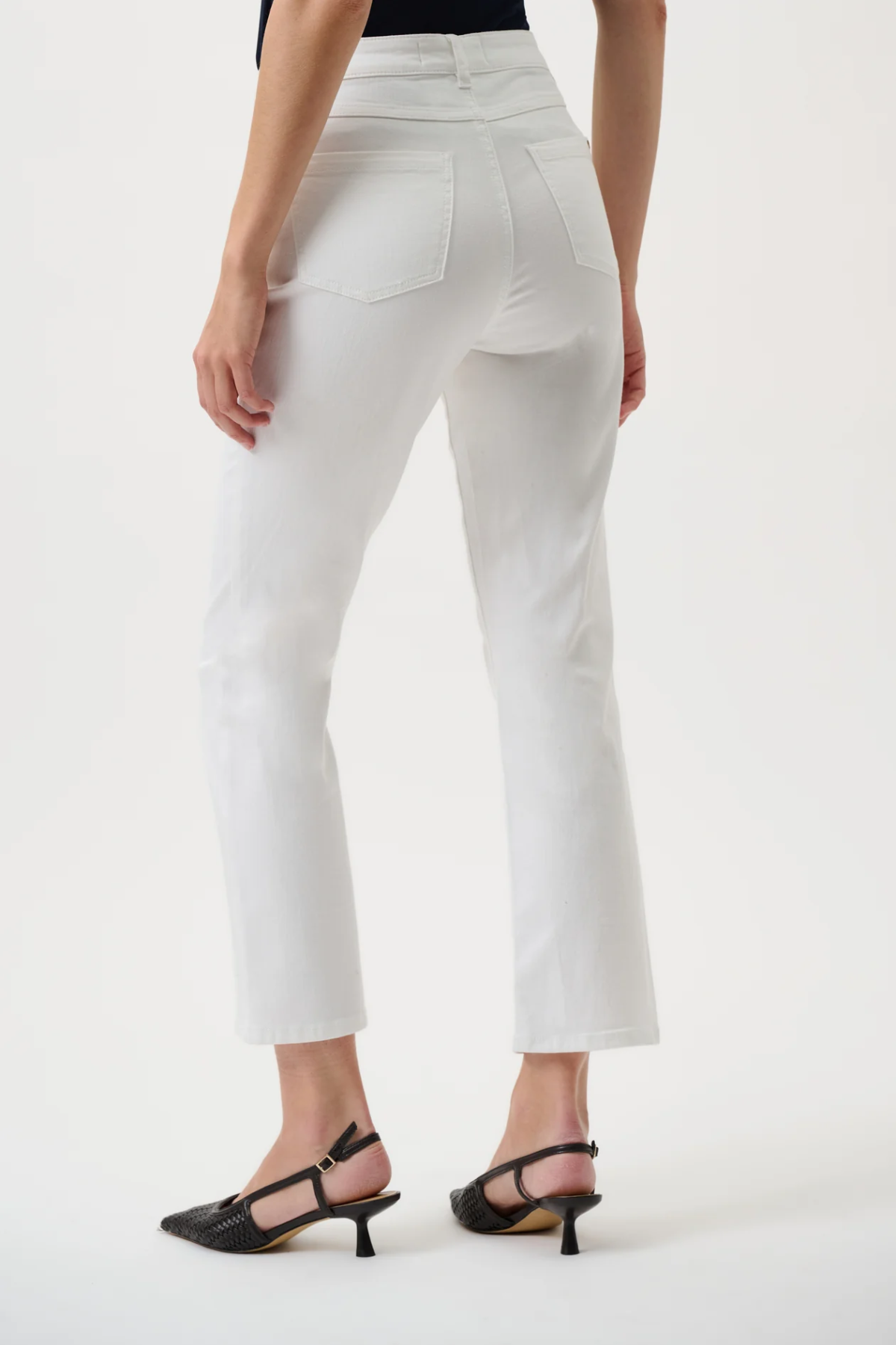 White pants worn by a person on a white background