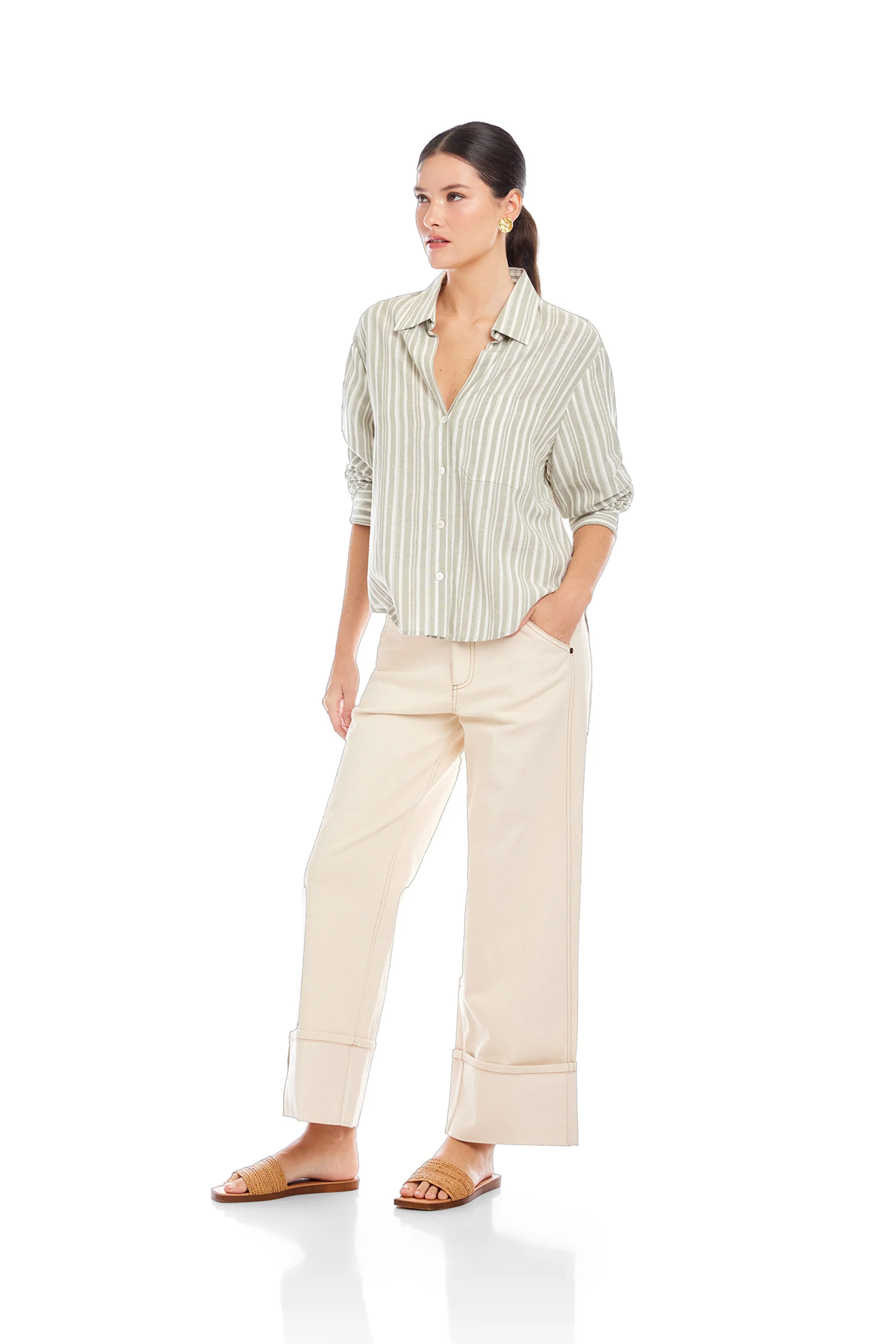 Woman wearing a striped shirt and beige pants on a white background