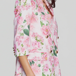 side of woman in floral blazer on white background 