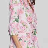 side of woman in floral blazer on white background 