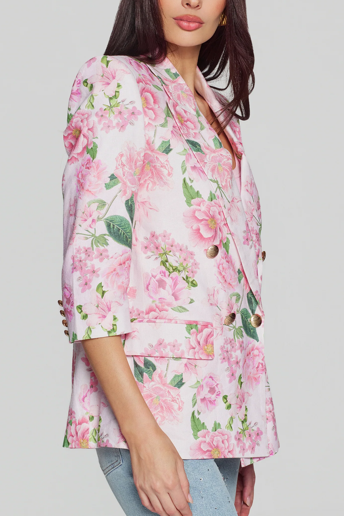 side of woman in floral blazer on white background 