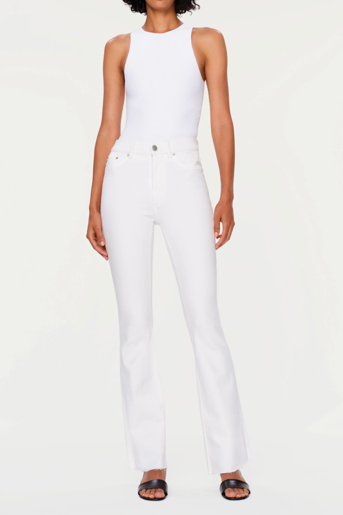 Person wearing a white sleeveless top and pants on a white background