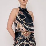 Model wearing a sleeveless printed halter top with a coordinating floral-inspired pattern and relaxed silhouette.