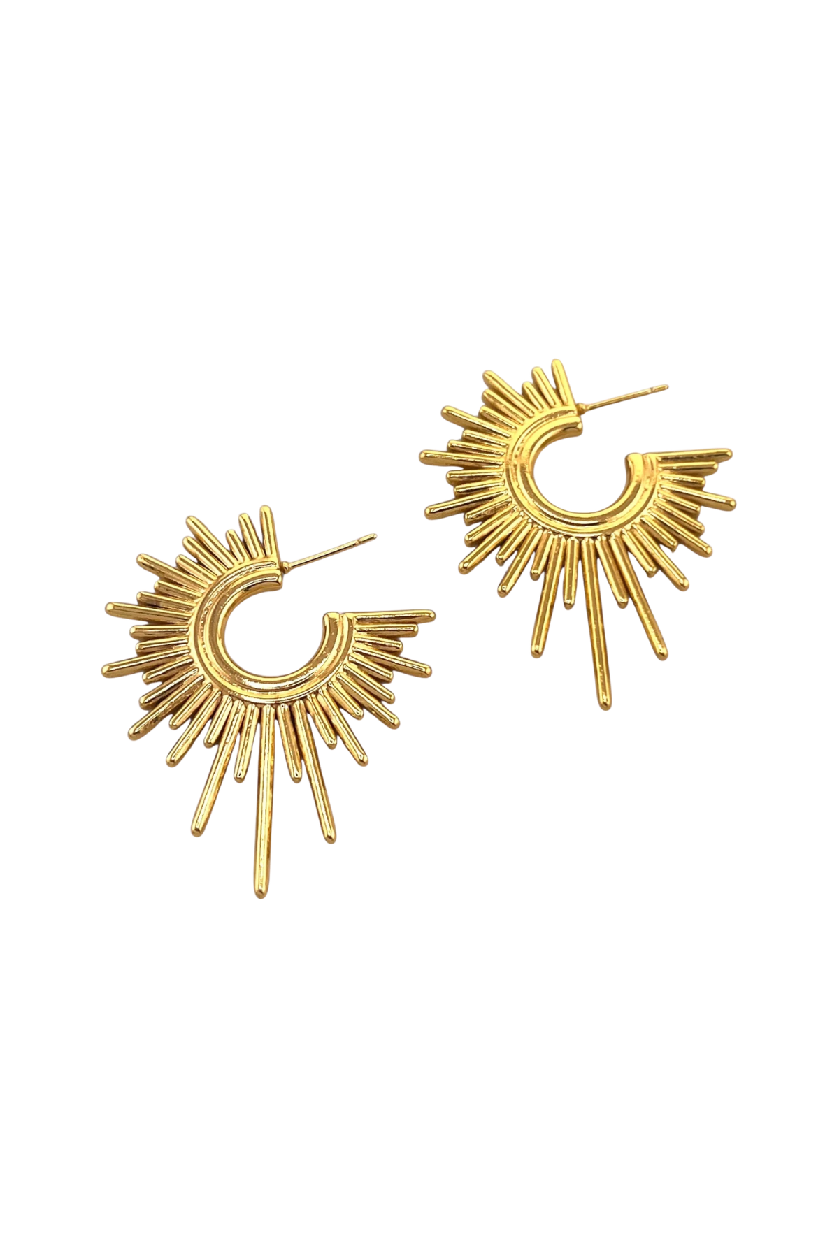 Gold sunburst earrings on a white background