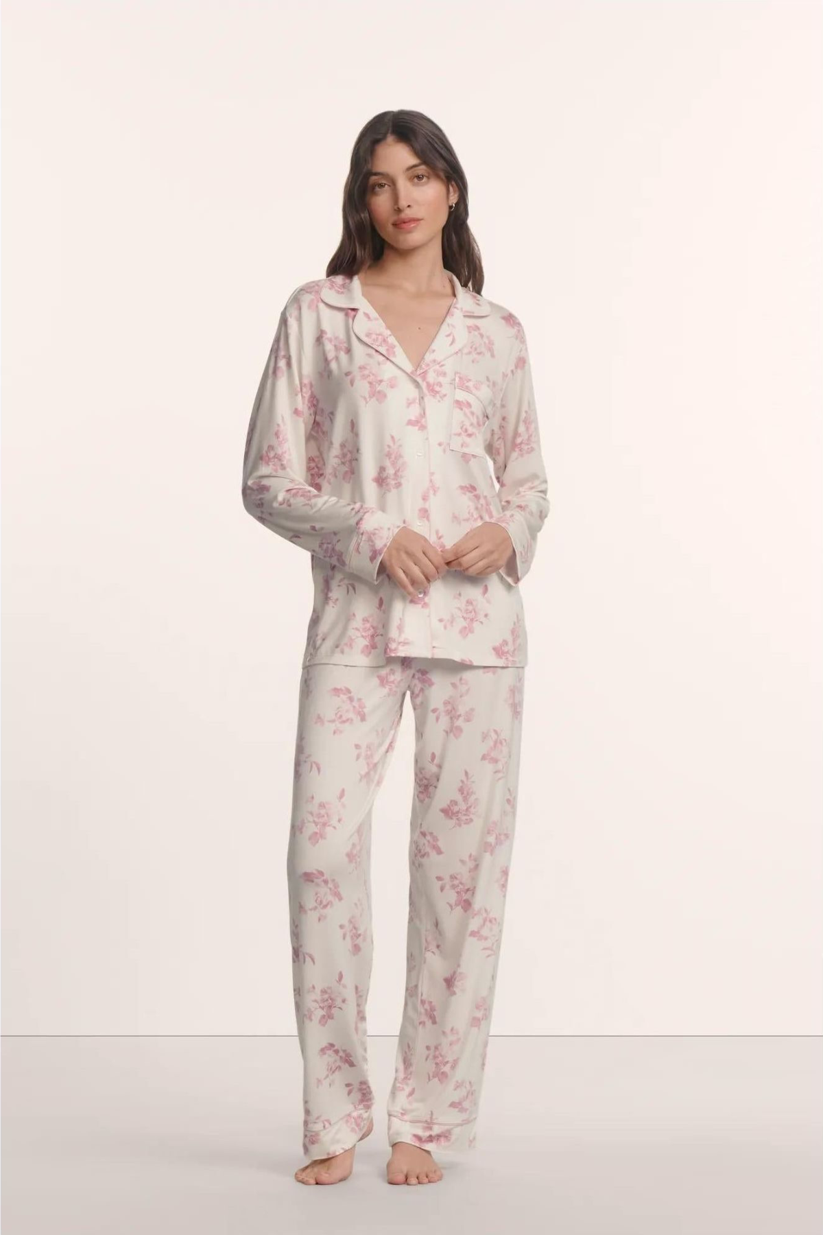 Woman wearing a floral pajama set on a white background