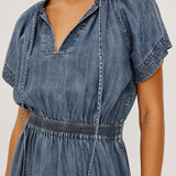 Denim dress with puff sleeves on a plain background