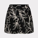 Black skirt with white floral pattern on a light gray background