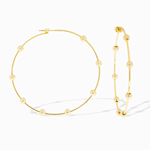 Gold hoop earrings with bead detailing on a white background