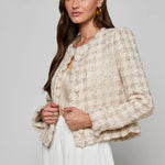 Collarless tailored jacket in a neutral tone, styled over a lightweight top