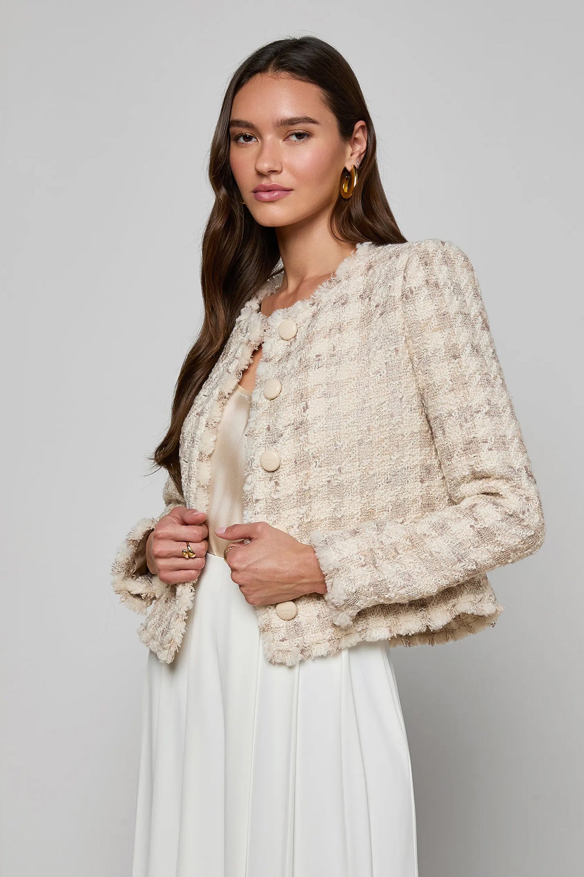 Collarless tailored jacket in a neutral tone, styled over a lightweight top