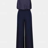 Women's black halter-neck jumpsuit featuring a sleeveless design and full-length silhouette.