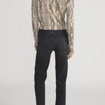 Cashmere cardigan with subtle snake pattern, styled with dark denim