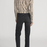 Cashmere cardigan with subtle snake pattern, styled with dark denim