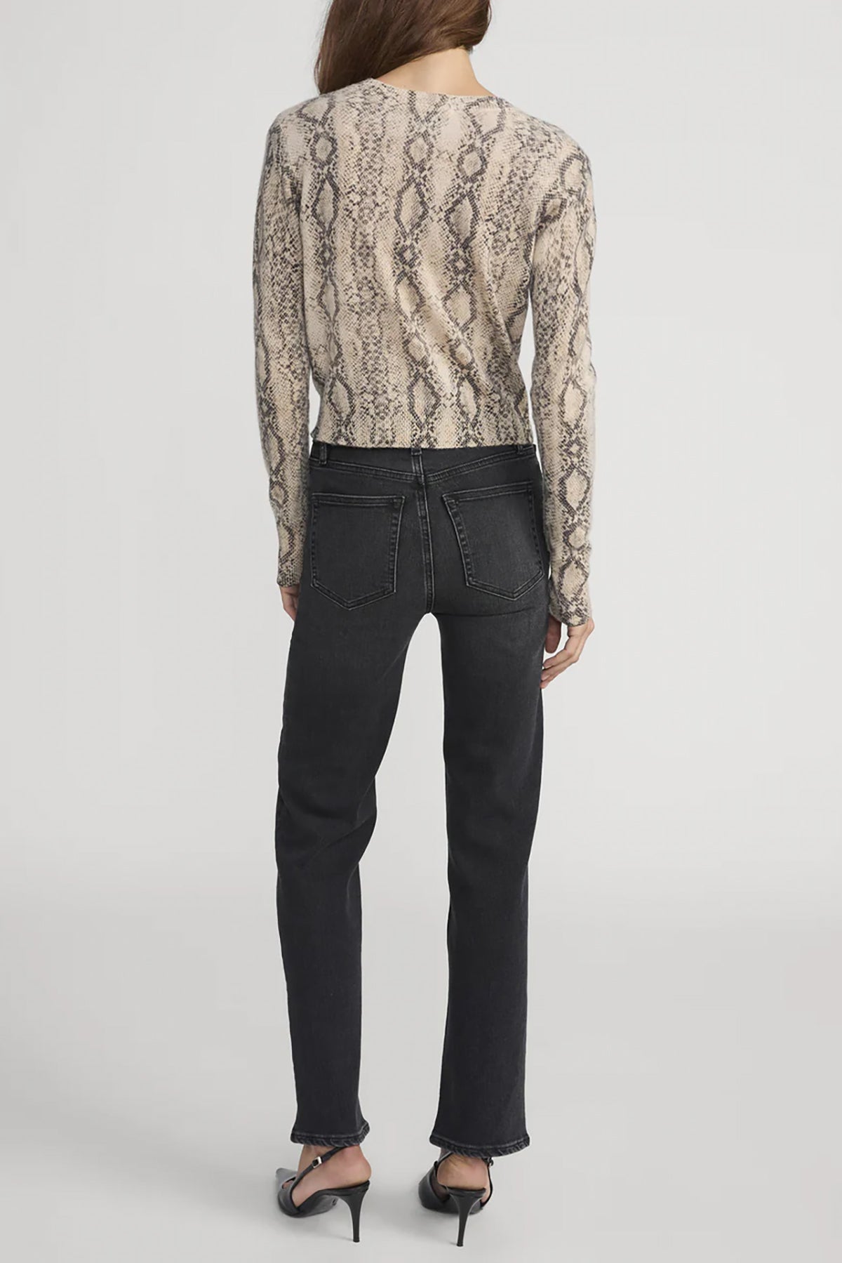 Cashmere cardigan with subtle snake pattern, styled with dark denim