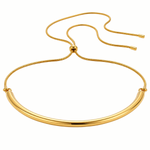 A gold-toned metal necklace with a thick, polished curved bar and a thin adjustable snake chain closure, shown on a plain white background.