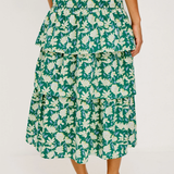 Woman wearing a green floral dress on a white background