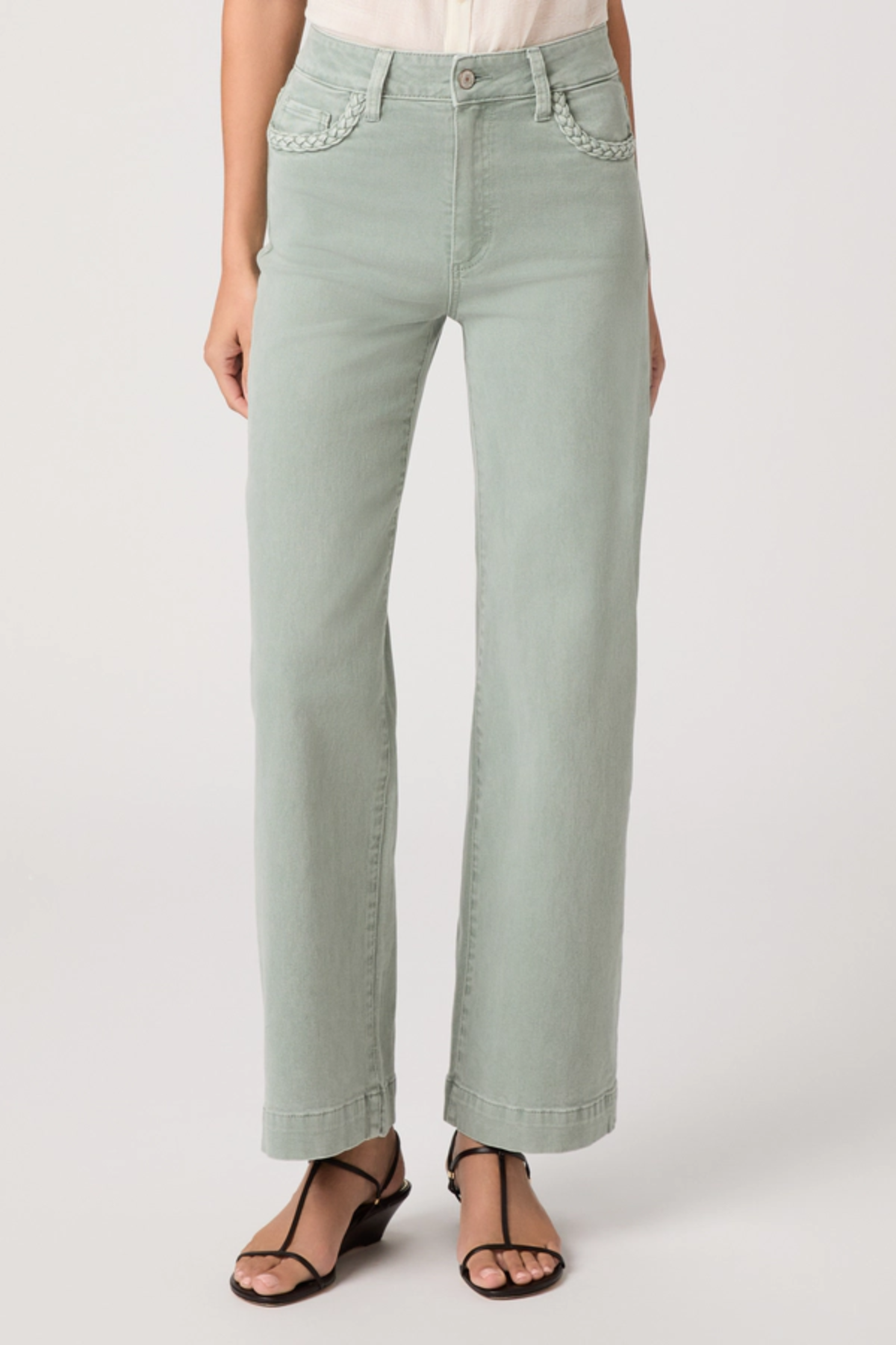 Light green jeans worn by a person on a white background