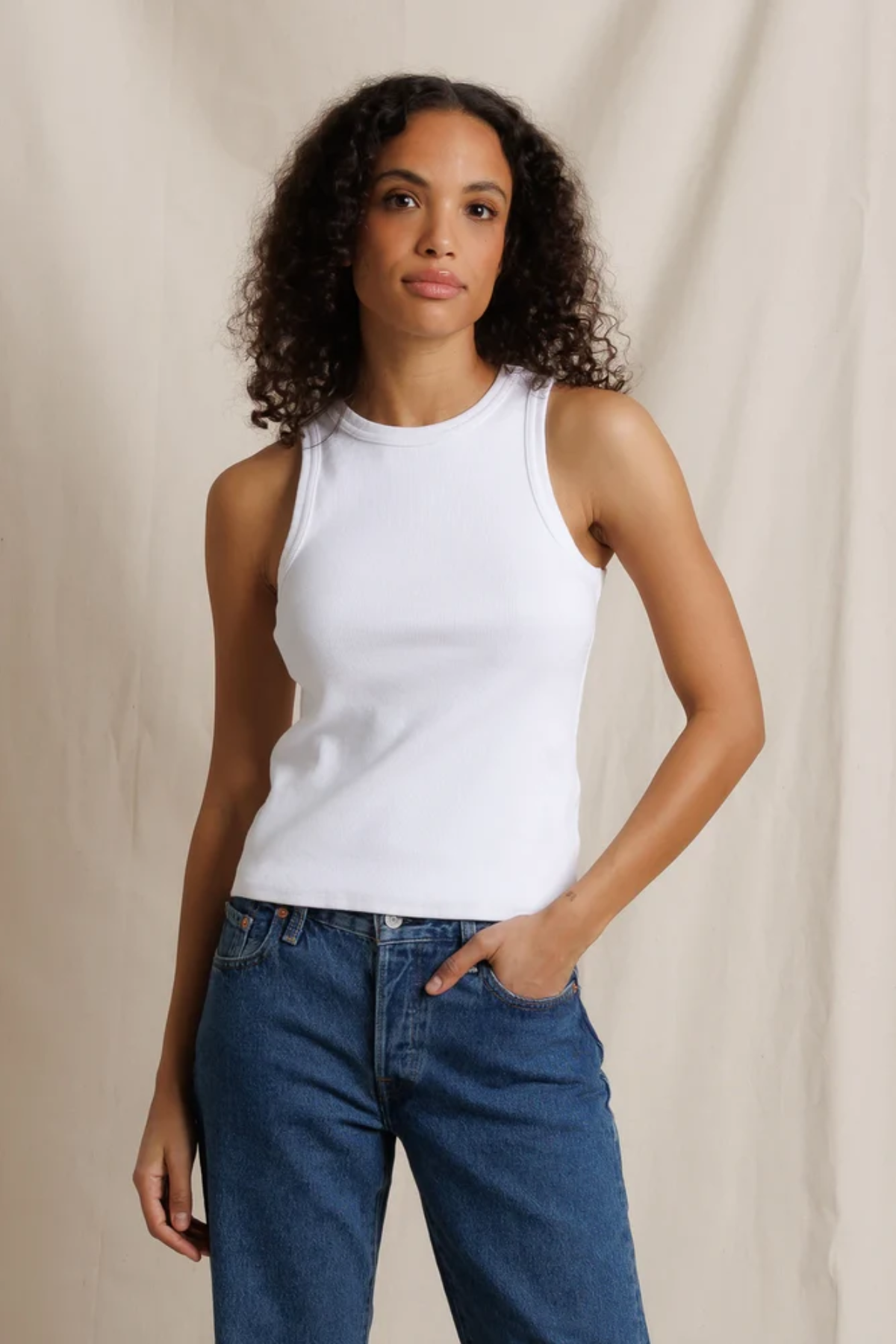 woman in white tank on white background 