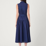 Model wearing a sleeveless midi dress with a fitted bodice and feminine, timeless silhouette.
