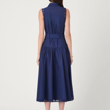 Model wearing a sleeveless midi dress with a fitted bodice and feminine, timeless silhouette.