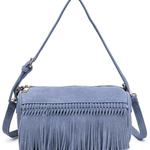A dusty blue suede crossbody bag with a long fringe trim across the front, a top zipper closure, and a matching adjustable shoulder strap, shown on a plain white background.