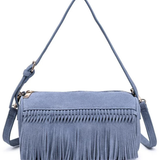 A dusty blue suede crossbody bag with a long fringe trim across the front, a top zipper closure, and a matching adjustable shoulder strap, shown on a plain white background.