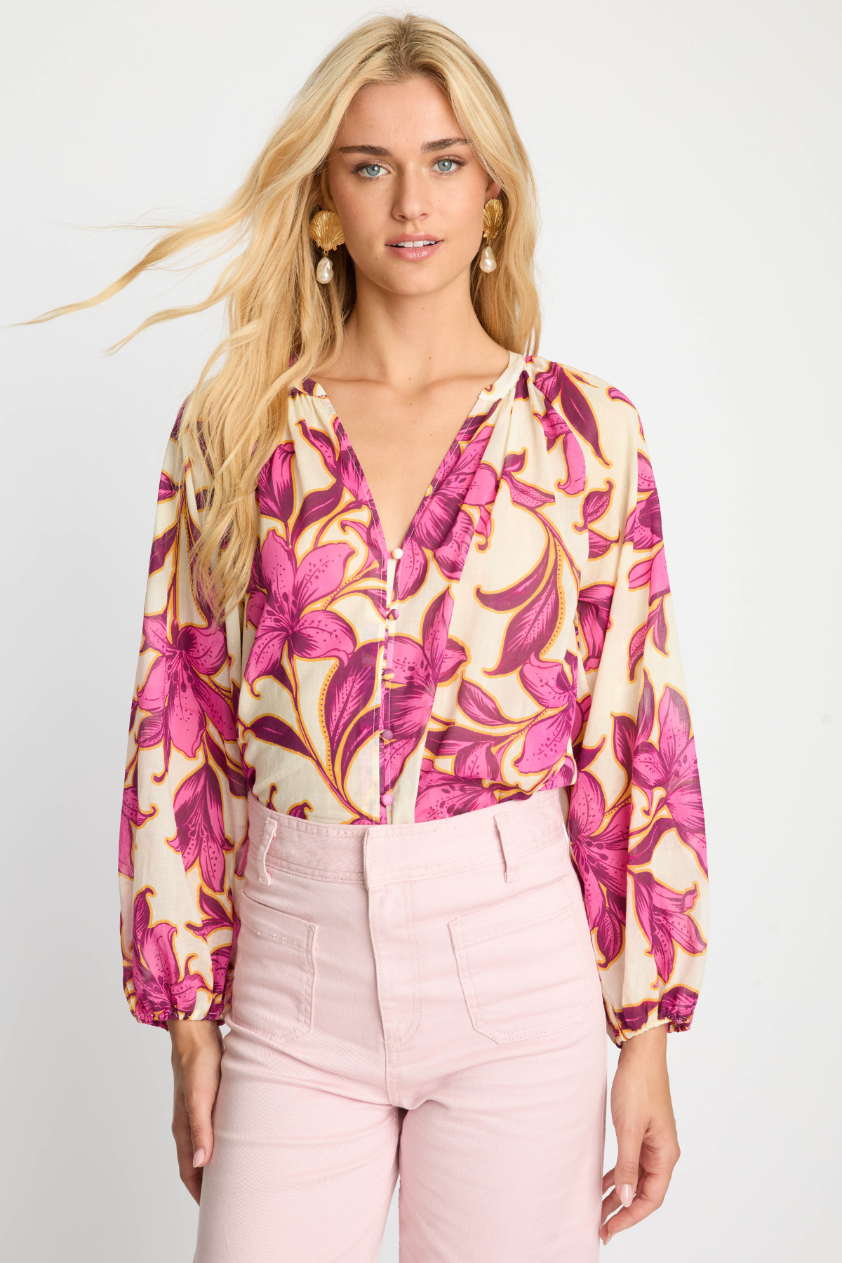 woman in pink printed blouse on white background 