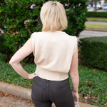 Sleeveless knit muscle sweater vest styled with trousers