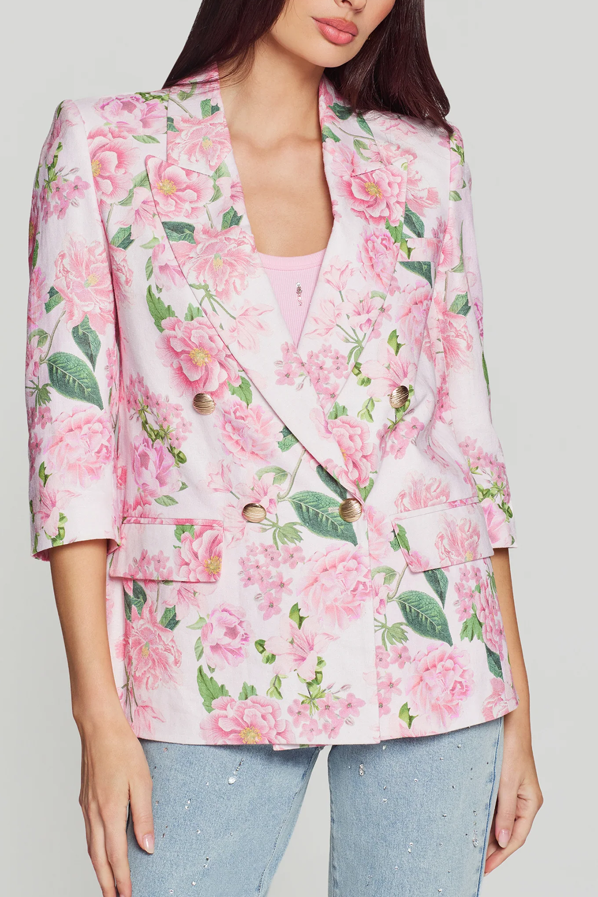 woman in floral printed blazer on white background 