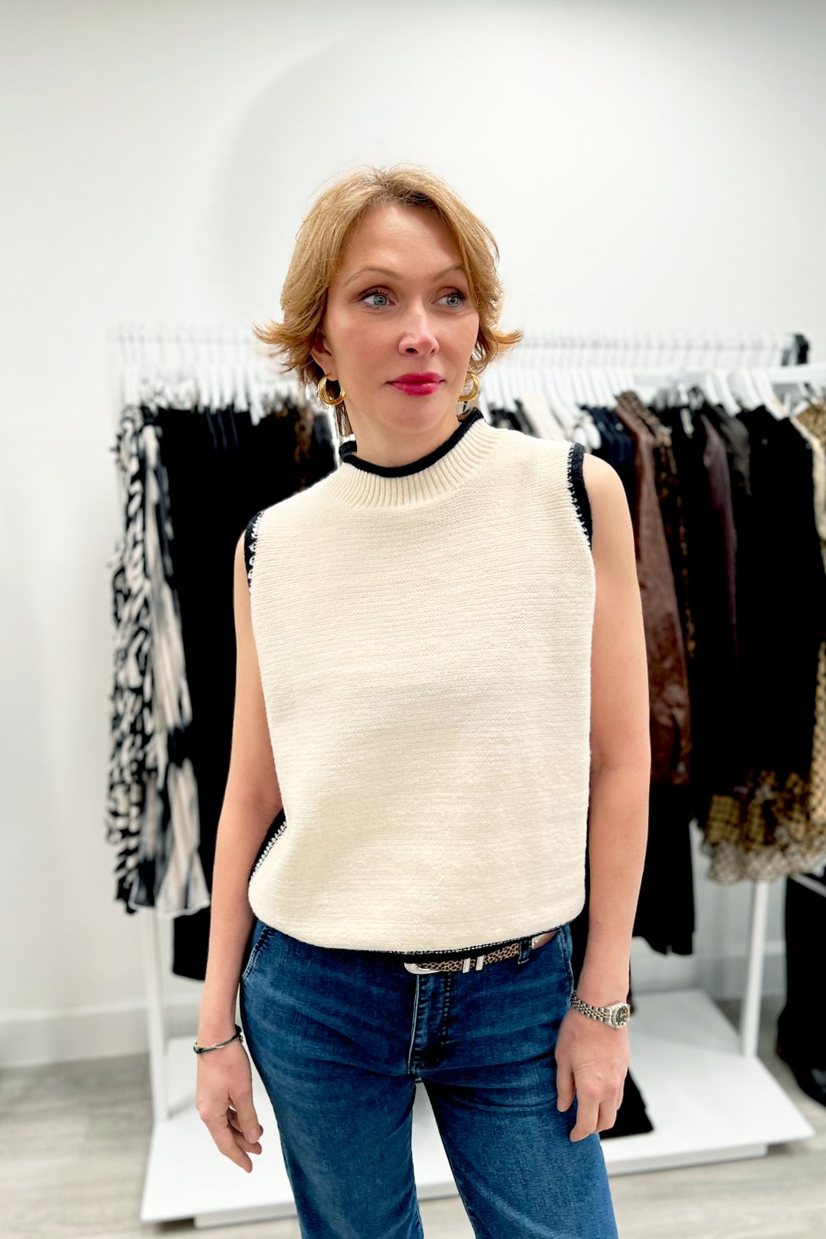 Mock neck sleeveless knit sweater top in a classic neutral shade